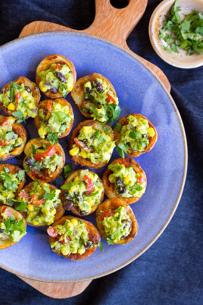 Roasted Potato Cups with Loaded Guacamole on a blue plate