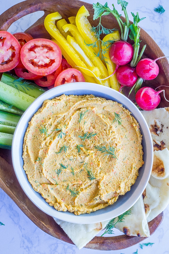 This Roasted Carrot and Dill Hummus is so fresh and flavorful! It's easy to make and perfect for a spring appetizer or snack! Gluten free and vegan too!
