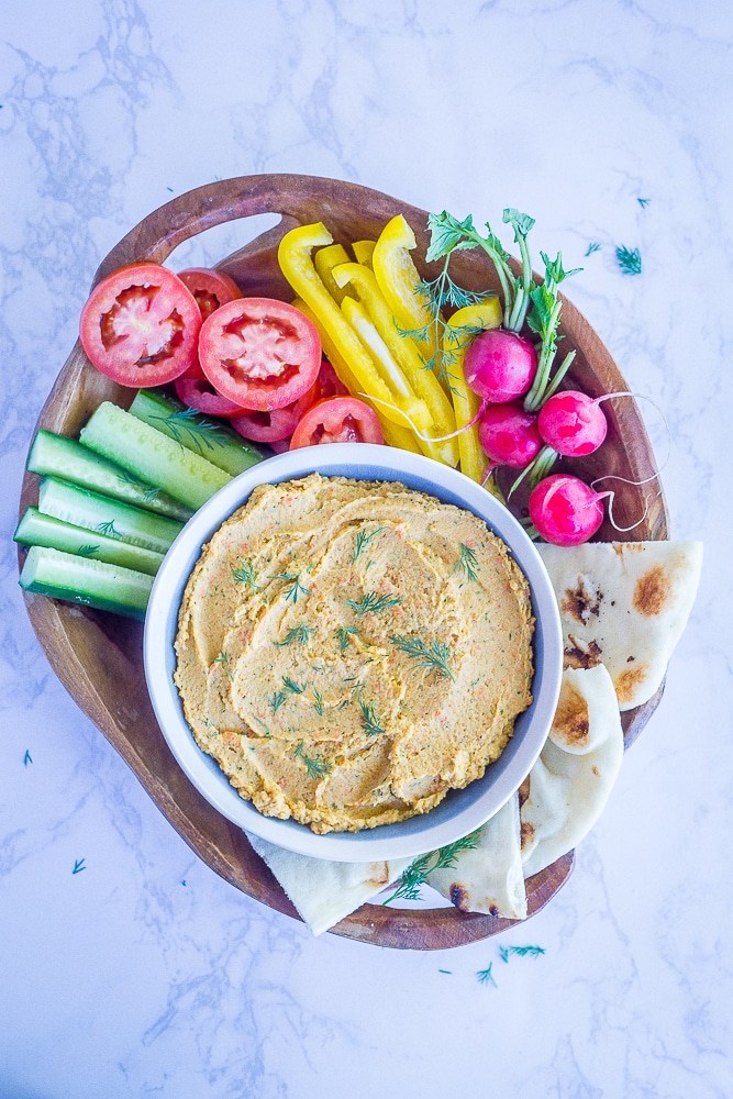 This Roasted Carrot and Dill Hummus is so fresh and flavorful! It's easy to make and perfect for a spring appetizer or snack! Gluten free and vegan too!