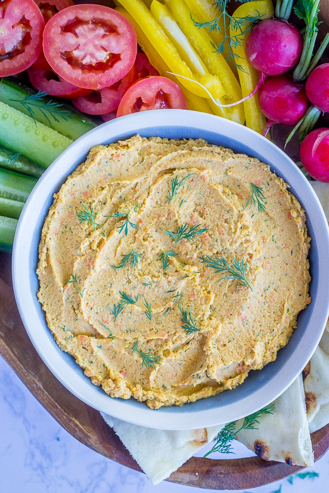 This Roasted Carrot and Dill Hummus is so fresh and flavorful! It's easy to make and perfect for a spring appetizer or snack! Gluten free and vegan too!