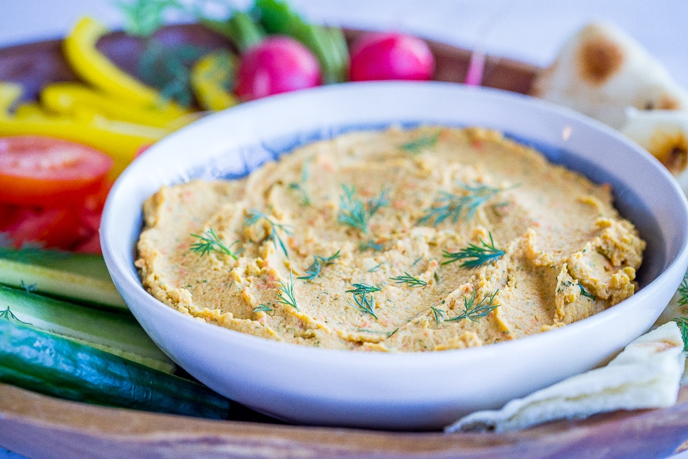 This Roasted Carrot and Dill Hummus is so fresh and flavorful! It's easy to make and perfect for a spring appetizer or snack! Gluten free and vegan too!