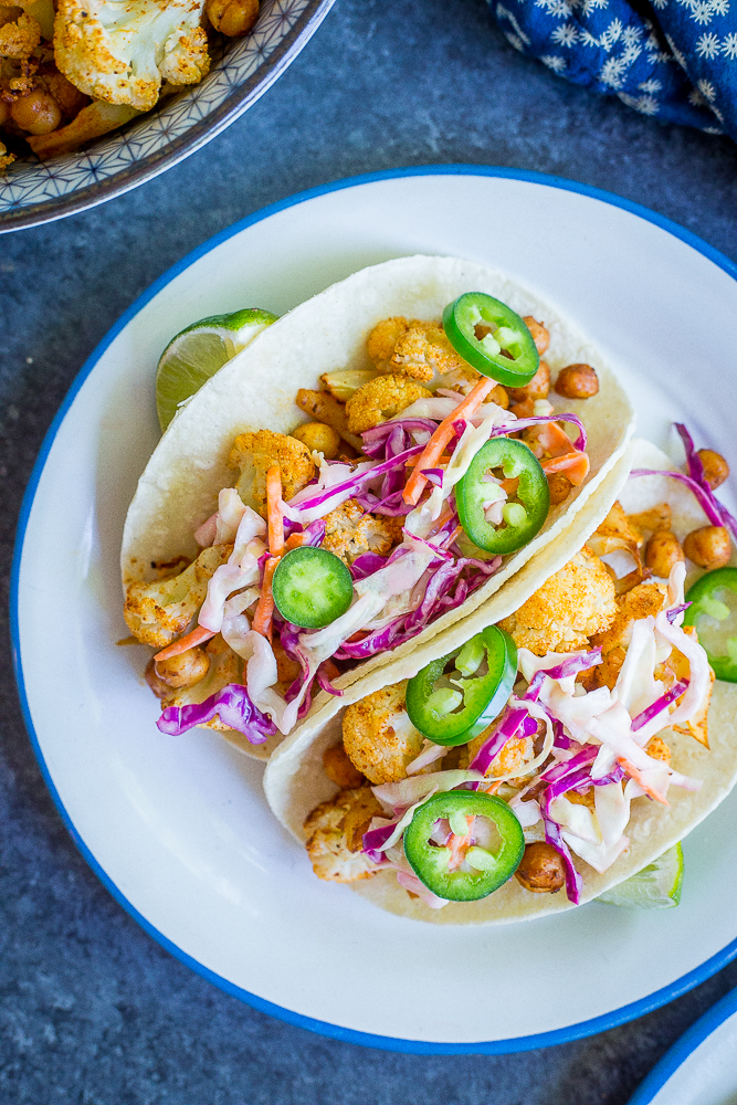 These BBQ Cauliflower and Chickpea Tacos with Creamy Lime Slaw are a delicious, filling and flavorful vegan dinner that everyone will love! They're so easy to make too! Gluten free/ vegan/ vegetarian/ dinner