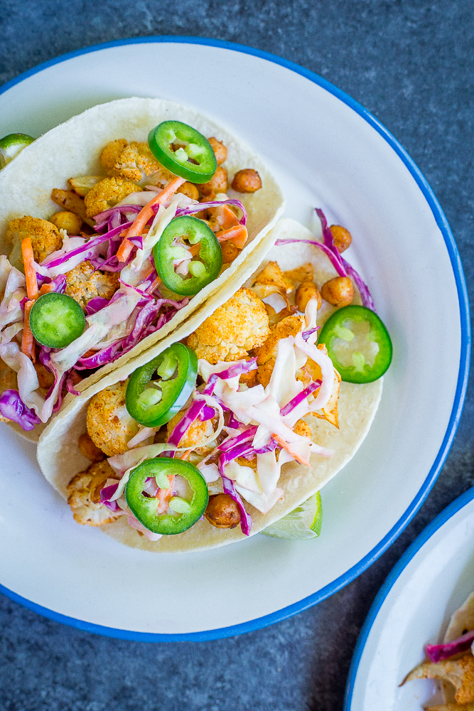 These BBQ Cauliflower and Chickpea Tacos with Creamy Lime Slaw are a delicious, filling and flavorful vegan dinner that everyone will love! They're so easy to make too! Gluten free/ vegan/ vegetarian/ dinner