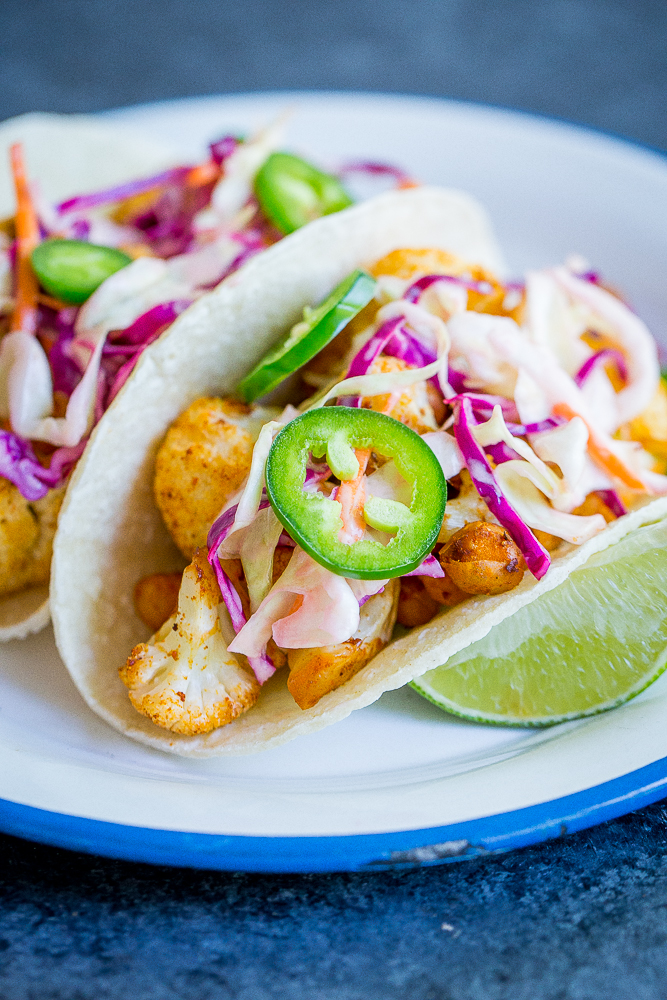 These BBQ Cauliflower and Chickpea Tacos with Creamy Lime Slaw are a delicious, filling and flavorful vegan dinner that everyone will love! They're so easy to make too! Gluten free/ vegan/ vegetarian/ dinner