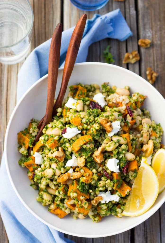 a bowl of sorghum sweet potato and white bean salad with kale pesto