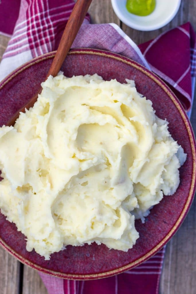parmesan wasabi mashed potatoes in a bowl with a serving spoon