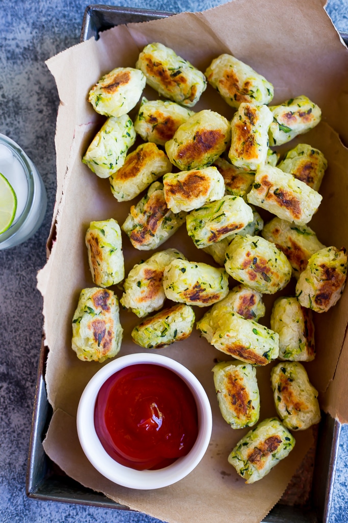 tray of zucchini tater tots with ketchup