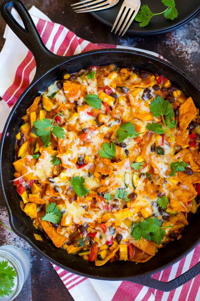 Stove top enchiladas in a skillet with cilantro