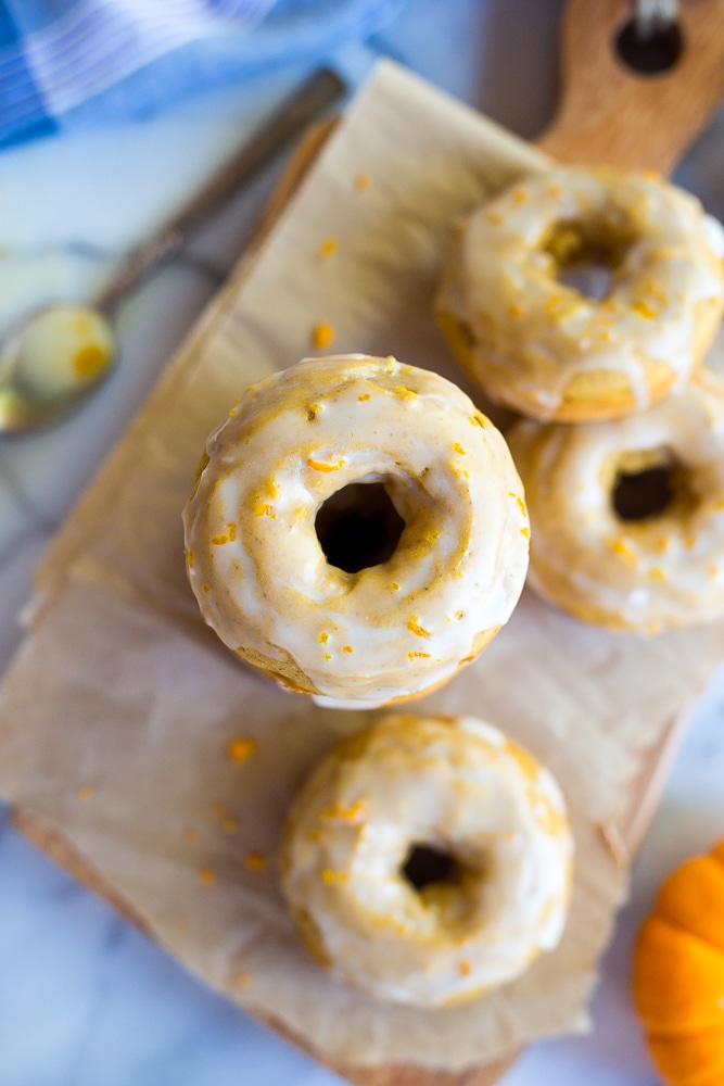 a stack of gluten free pumpkin donuts with glaze
