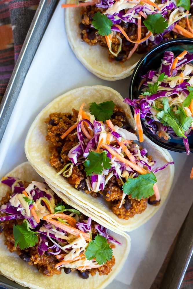 These BBQ Black Bean & Quinoa Tacos with Cilantro Slaw are so flavorful and delicious! They will be your new favorite tacos! Packed with protein and perfect for your next taco night!