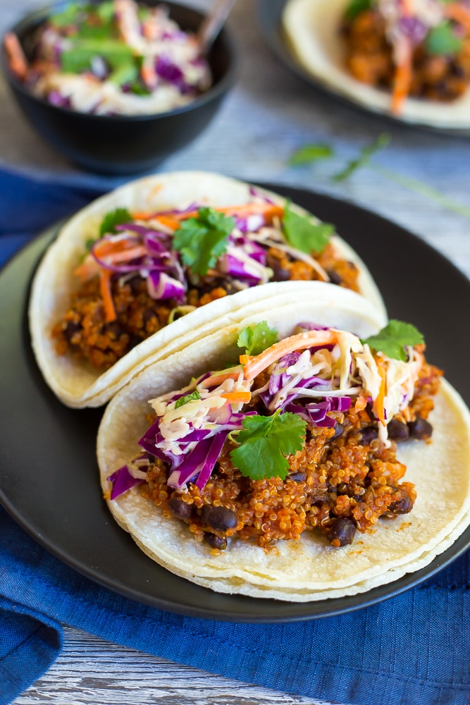 These BBQ Black Bean & Quinoa Tacos with Cilantro Slaw are so flavorful and delicious! They will be your new favorite tacos! Packed with protein and perfect for your next taco night!