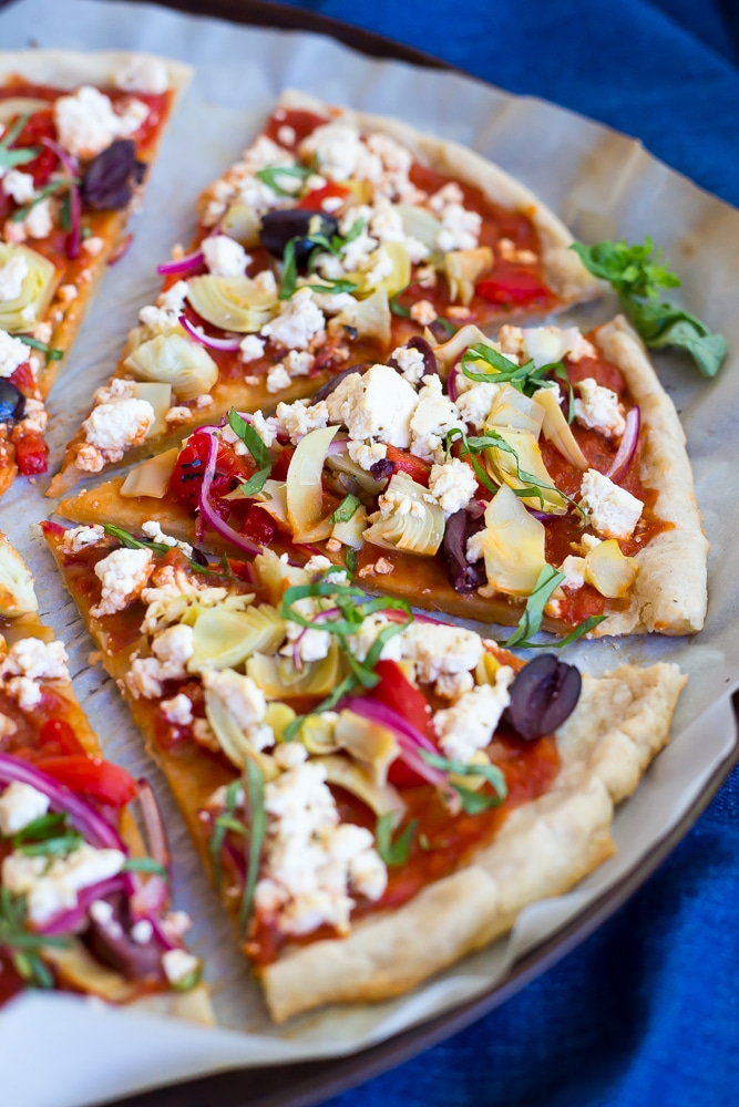 This Vegan Greek Pizza is so full of delicious and fresh flavor that you won't even miss the dairy!  Vegan tofu feta adds tons of creaminess and tang!  Perfect for your next pizza night!