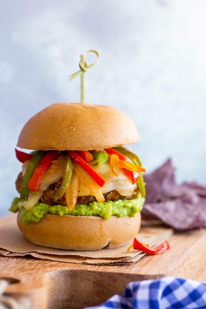 Jazz up your veggie burgers by making these Black Bean Fajita Veggie Burgers!  Topped with fajita peppers and onions, pepperjack cheese and guacamole! {gluten free}