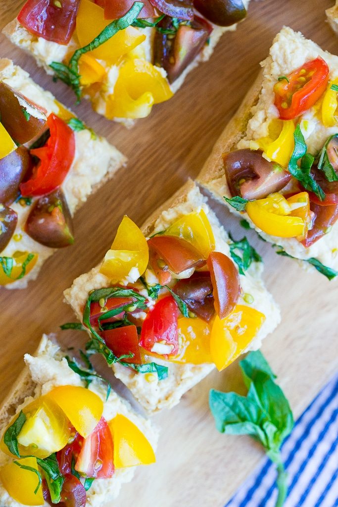 This Roasted Garlic Hummus Bruschetta is a delicious snack that is packed with so much fresh flavor! {gluten free, vegan}