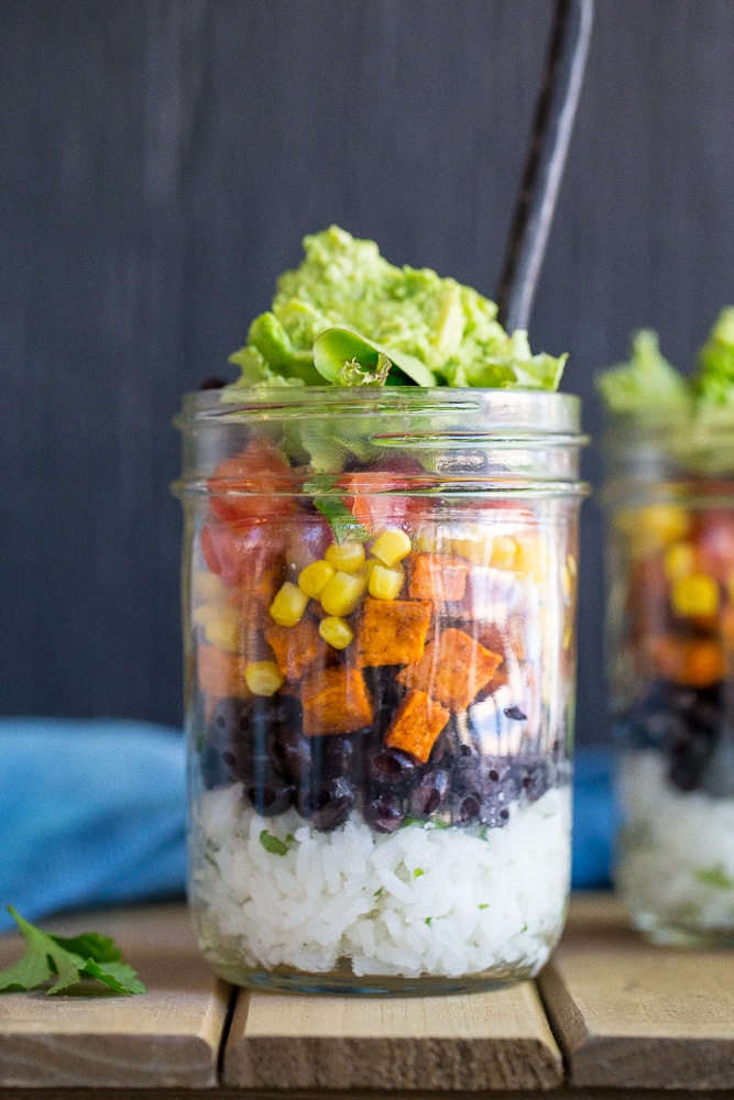 These Vegetarian Mason Jar Burrito Bowls can be made ahead of time and eaten for lunches or dinner!  Easy to assemble and lots of great flavors!  Vegan and gluten free.