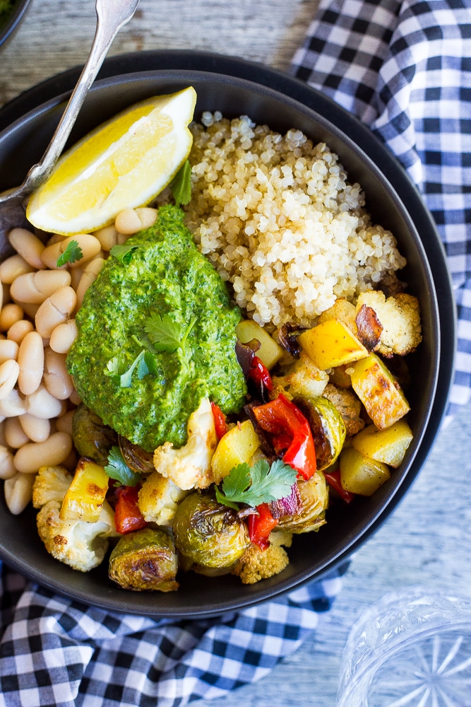 These Roasted Veggie Buddha Bowls are so healthy and delicious!  Just put everything in one bowl for a perfect comfort food dinner!  All topped off with some refreshing pesto.  Gluten free and vegan!