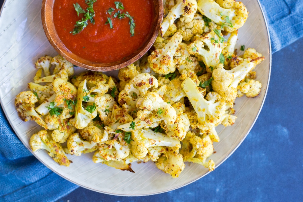 Baked Cauliflower Pizza Bites- These would be a great healthy afternoon snack or the perfect side dish for dinner!  Make them as a healthier option to go with your next pizza night!  Gluten free and vegan!