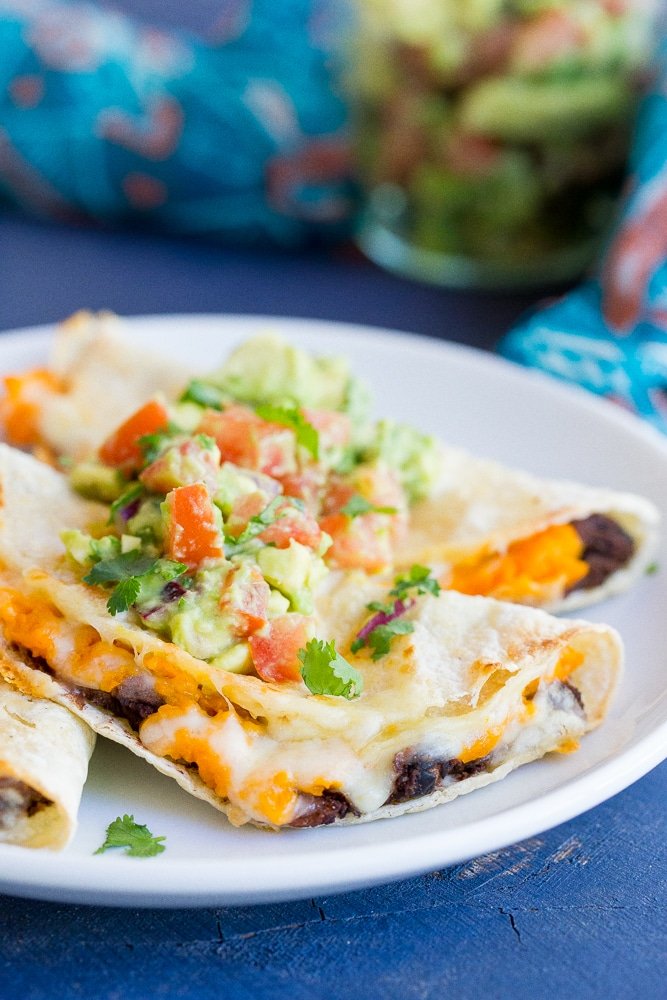 Crispy Baked Black Bean & Sweet Potato Tacos- These delicious tacos only take 30 minutes to make! They're perfect for a quick and easy vegetarian dinner recipe with some Mexican flare!