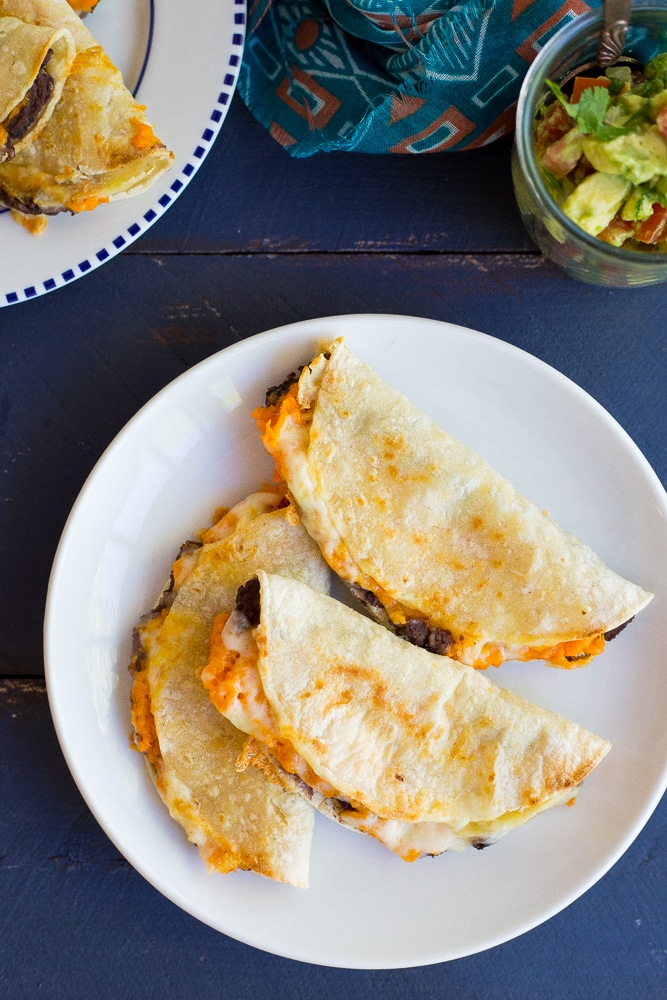 Crispy Baked Black Bean & Sweet Potato Tacos- These delicious tacos only take 30 minutes to make! They're perfect for a quick and easy vegetarian dinner recipe with some Mexican flare!