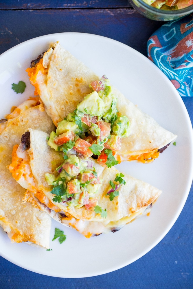 Crispy Baked Black Bean & Sweet Potato Tacos- These delicious tacos only take 30 minutes to make! They're perfect for a quick and easy vegetarian dinner recipe with some Mexican flare!