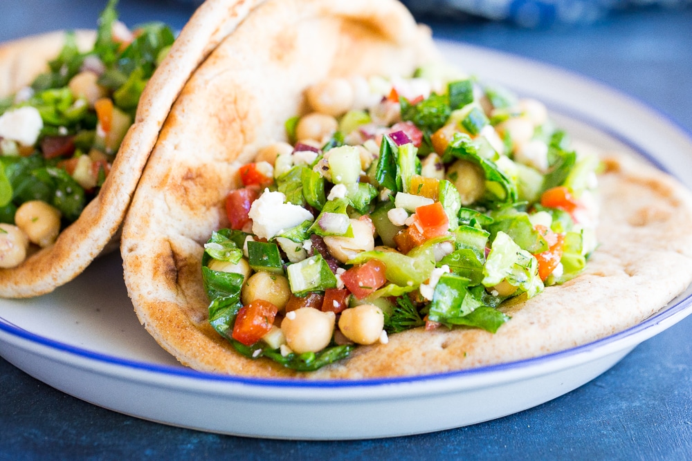 Mediterranean Chopped Salad Pitas- These delicious pitas are quick and easy to make and full of fresh vegetables. Perfect for a healthy lunch or no cook summer dinner!