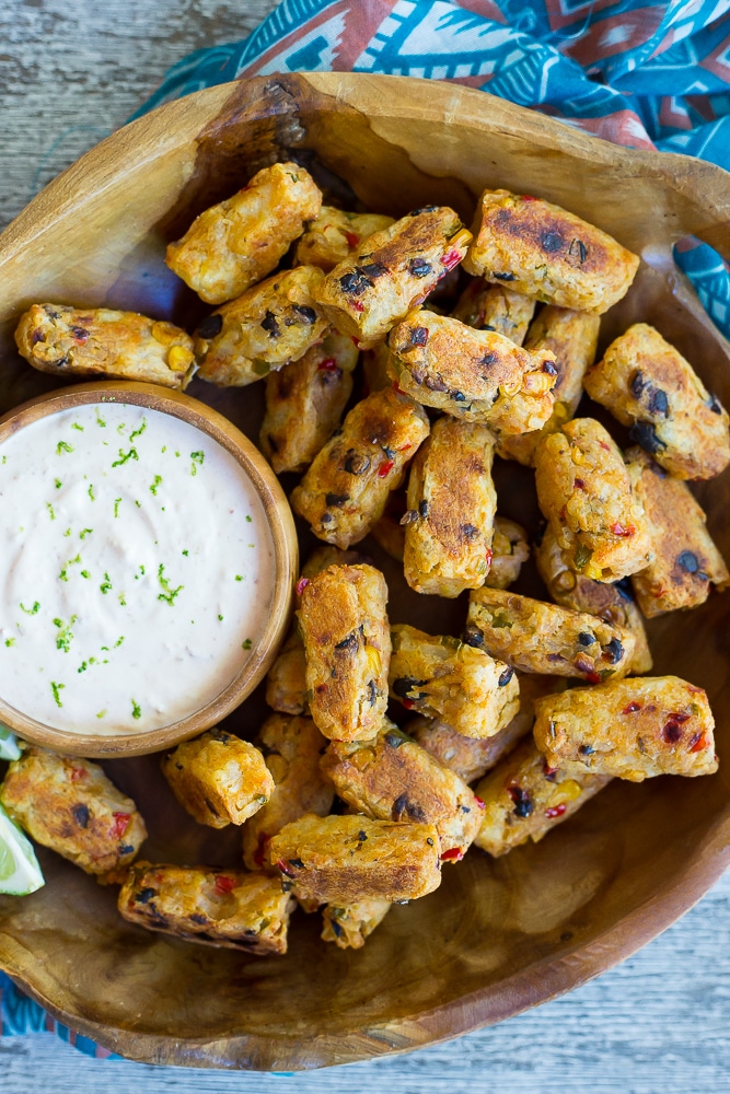 Tex Mex Tater Tots with Creamy Chipotle Lime Dip- Baked to perfection for a healthy and flavorful side dish! Dipped into a creamy and tangy dip! You'll never buy frozen tater tots again after you make your own! Gluten free, vegetarian