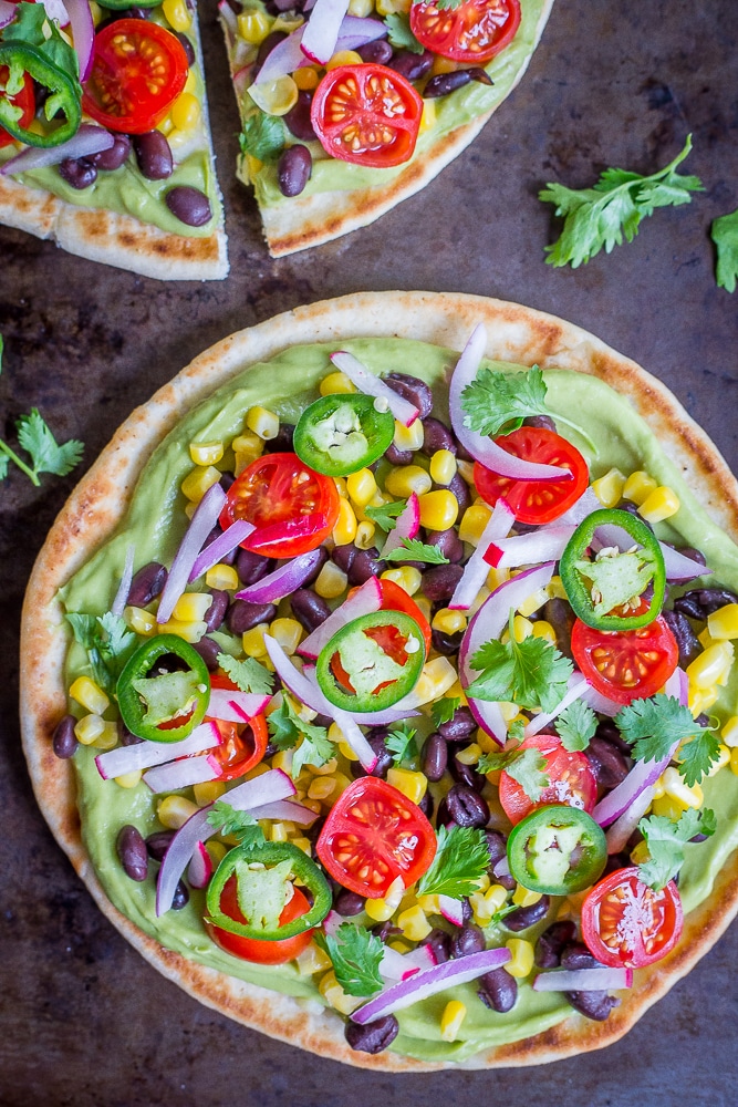 Guacamole Pita Pizzas- A delicious and easy 20 minute vegan no cook dinner that is packed with lots of healthy vegetables!