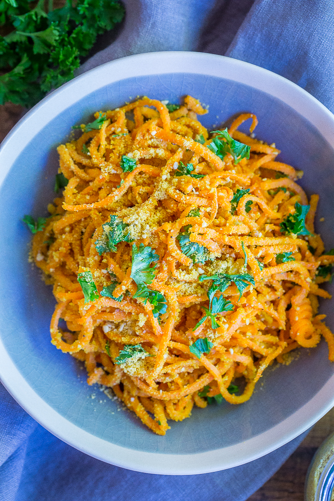 These Garlic Parmesan Sweet Potato Noodles are a fun and delicious side dish or can be eaten for dinner and lunch when you add a little protein! Easy to make, gluten free and vegan!