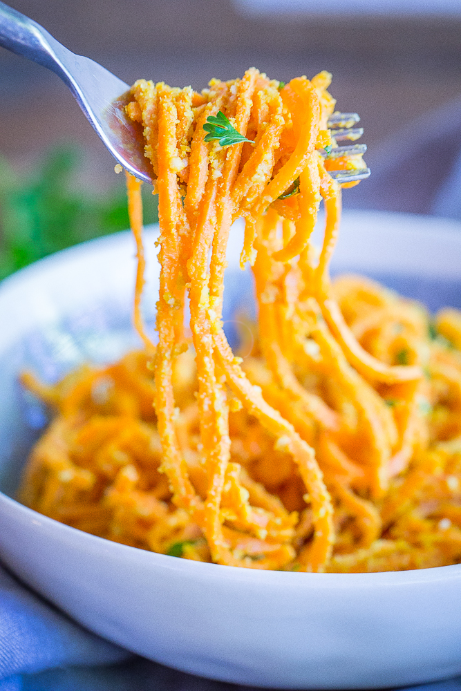 These Garlic Parmesan Sweet Potato Noodles are a fun and delicious side dish or can be eaten for dinner and lunch when you add a little protein! Easy to make, gluten free and vegan!