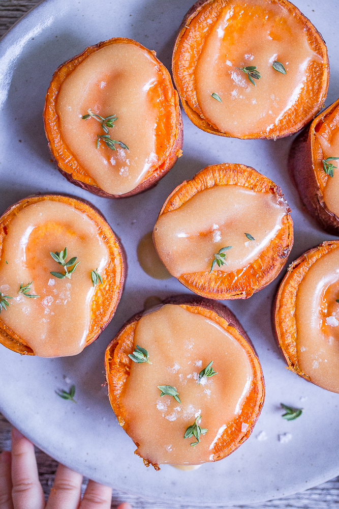 Roasted Sweet Potatoes with Tahini Maple Butter - These delicious and decedent sweet potatoes are so easy to make and are delicious as a side dish or snack! They're also vegan and gluten free!