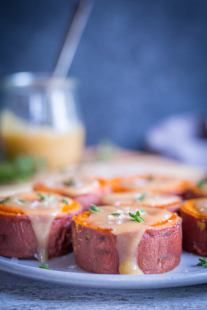 Roasted Sweet Potatoes with Tahini Maple Butter - These delicious and decedent sweet potatoes are so easy to make and are delicious as a side dish or snack! They're also vegan and gluten free!