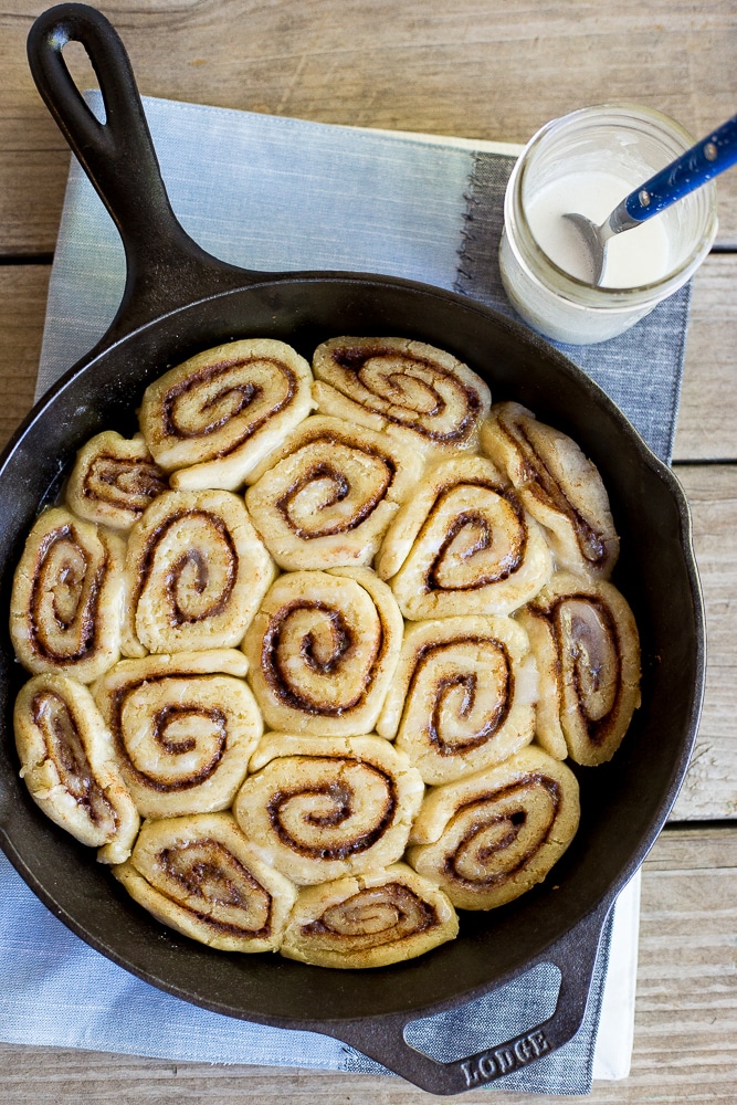 a cast iron skillet filled with gluten free cinnamon rolls