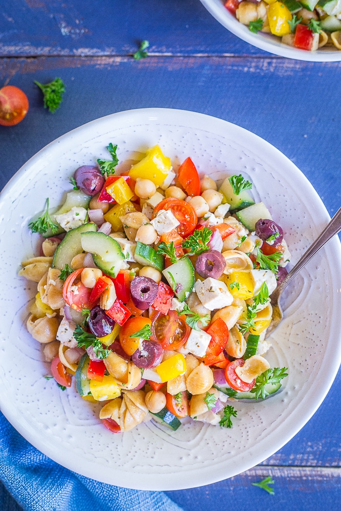 This Loaded Greek Pasta Salad is filled with lots of vegetables and protein! It's a delicious and healthy meal that can be eaten as a lunch or dinner. It's also vegan and gluten free!