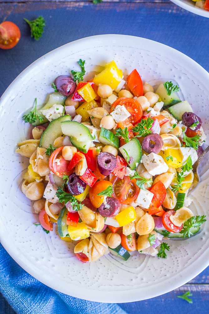 This Loaded Greek Pasta Salad is filled with lots of vegetables and protein! It's a delicious and healthy meal that can be eaten as a lunch or dinner. It's also vegan and gluten free!
