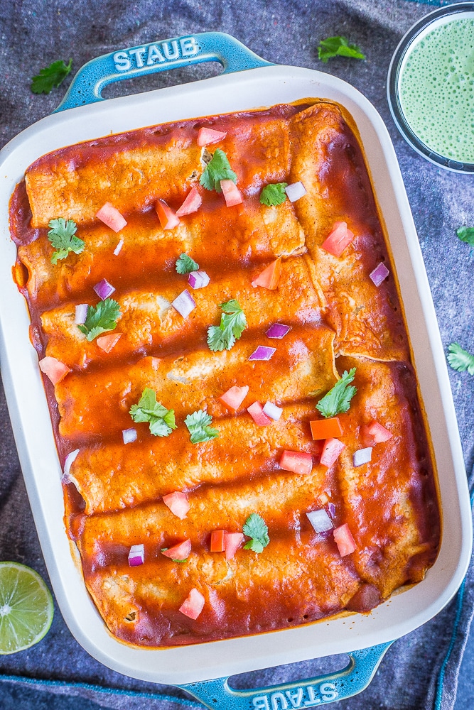 These Easy Spaghetti Squash and Black Bean Enchiladas are packed with flavor and so filling! They're made with roasted spaghetti squash, refried black beans and veggies. These delicious enchiladas are perfect for dinner and can easily be made ahead! Naturally gluten free and vegetarian!