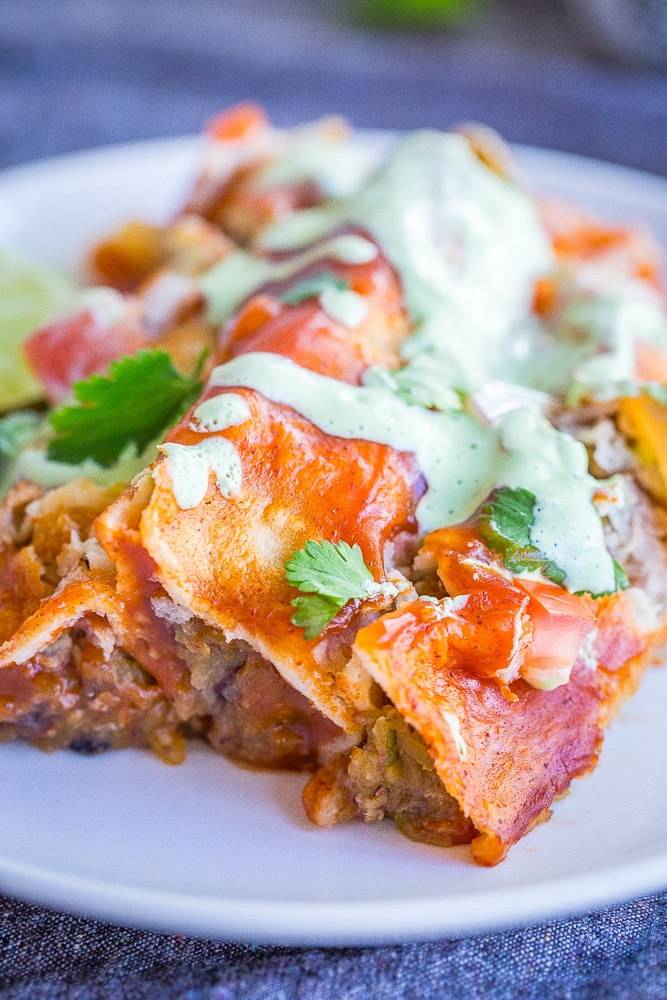 These Easy Spaghetti Squash and Black Bean Enchiladas are packed with flavor and so filling! They're made with roasted spaghetti squash, refried black beans and veggies. These delicious enchiladas are perfect for dinner and can easily be made ahead! Naturally gluten free and vegetarian!