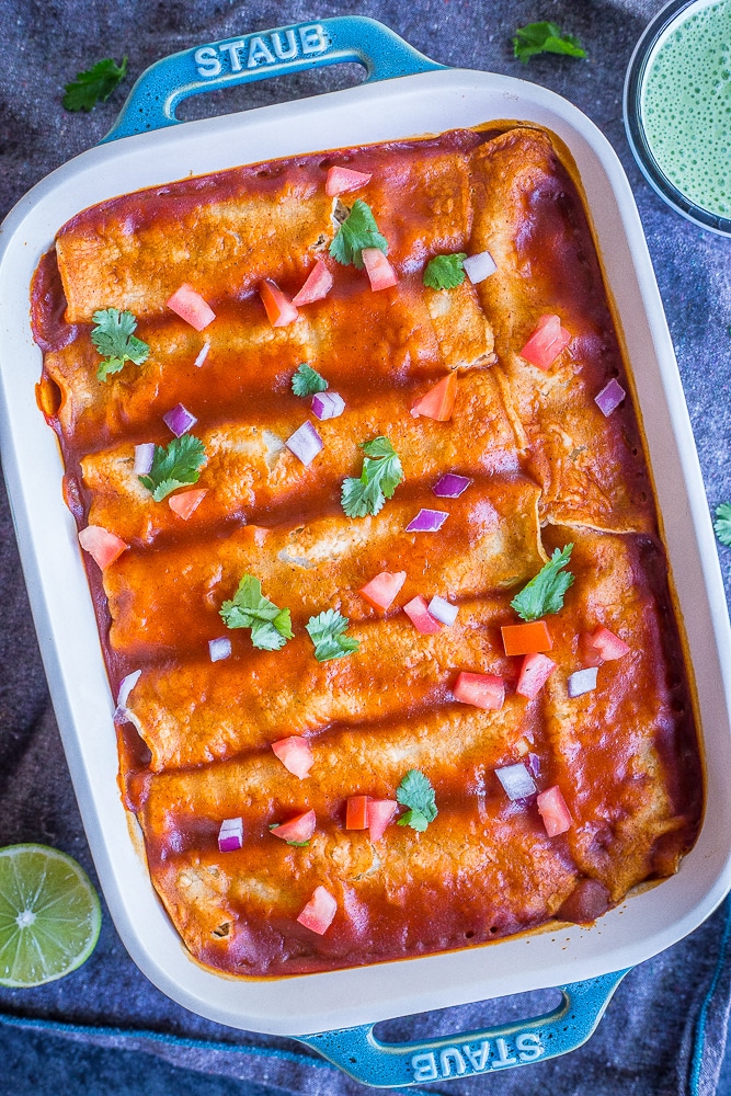 These Easy Spaghetti Squash and Black Bean Enchiladas are packed with flavor and so filling! They're made with roasted spaghetti squash, refried black beans and veggies. These delicious enchiladas are perfect for dinner and can easily be made ahead! Naturally gluten free and vegetarian!