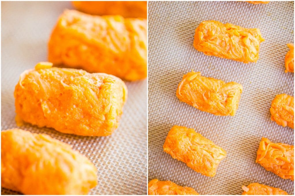 Raw sweet potato tots laying on a baking sheet