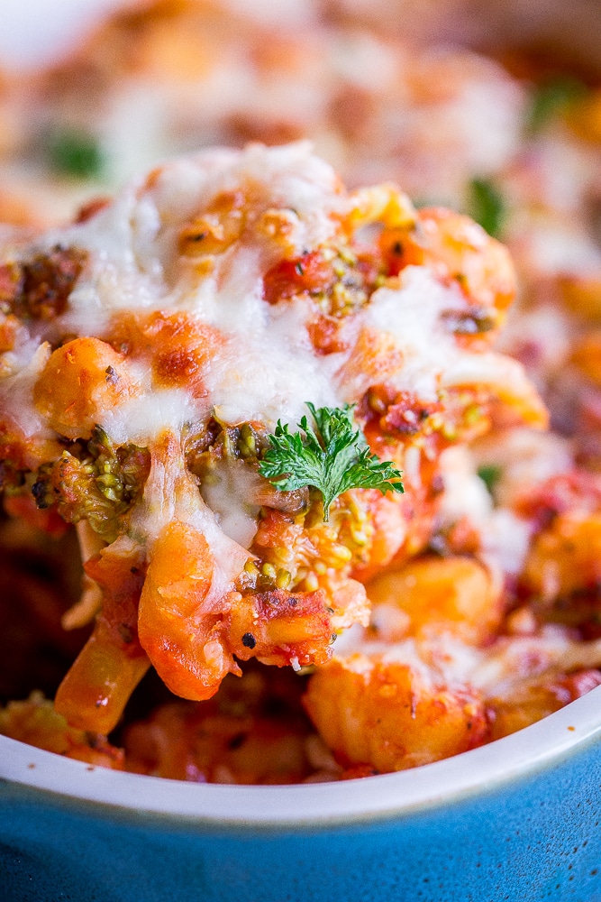 A spoonful of 5 Ingredient Gnocchi, Broccoli and White Bean Bake with cheese melted on top.