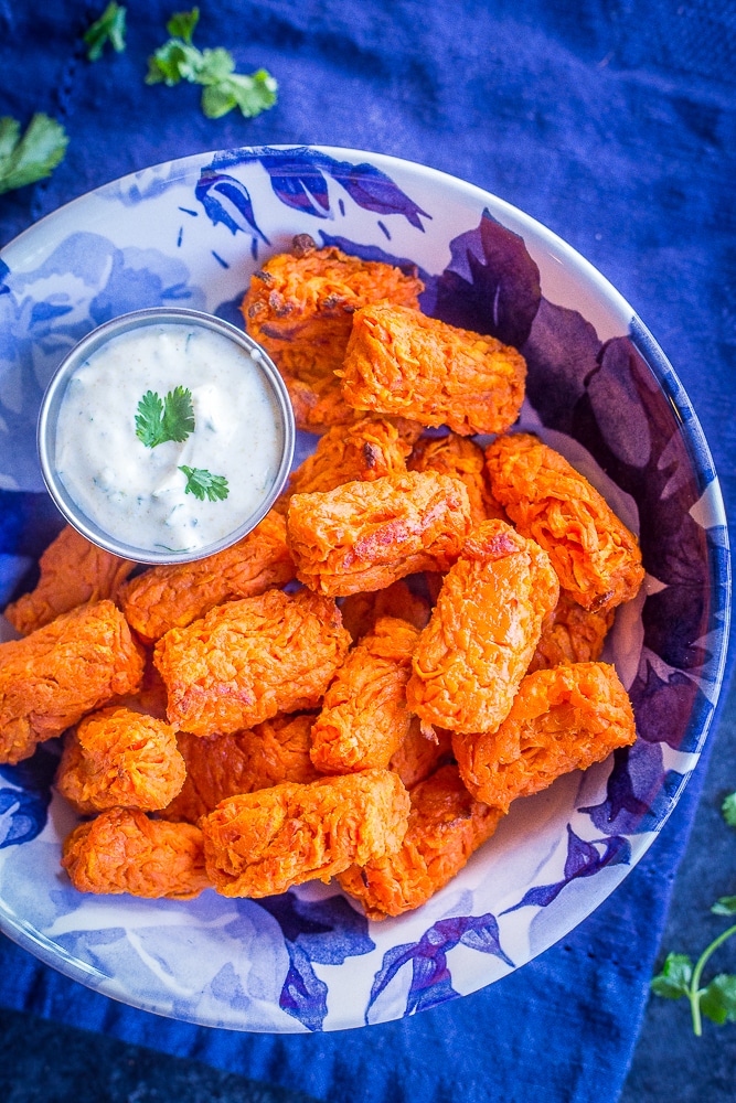 Sweet potato tots in a bowl with curry cilantro dip