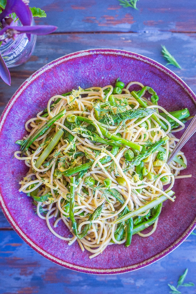 This Spring Vegetable Pasta with Lemon and Dill is so fresh and delicious! It's made with whole wheat spaghetti and packed with asparagus, peas, dill, lemon and garlic. Perfect for a quick and easy weeknight dinner! 