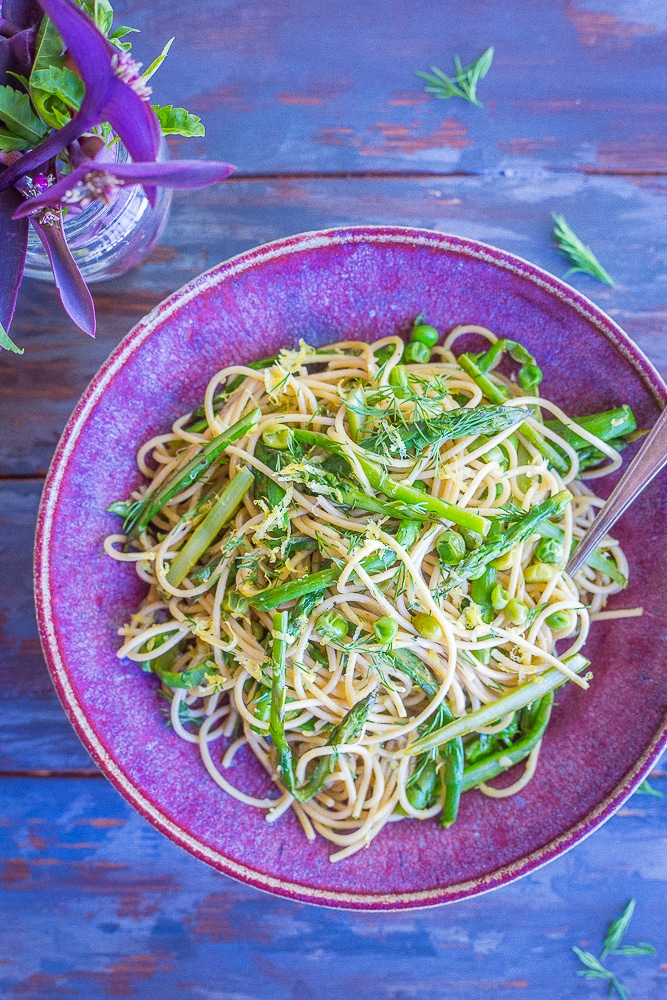 This Spring Vegetable Pasta with Lemon and Dill is so fresh and delicious! It's made with whole wheat spaghetti and packed with asparagus, peas, dill, lemon and garlic. Perfect for a quick and easy weeknight dinner! 