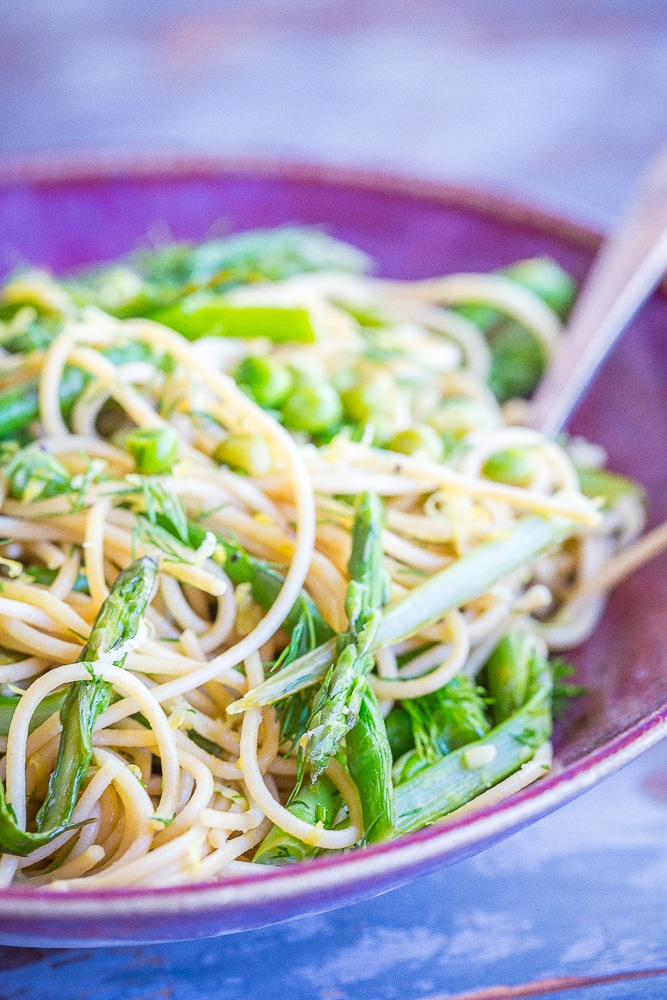 This Spring Vegetable Pasta with Lemon and Dill is so fresh and delicious! It's made with whole wheat spaghetti and packed with asparagus, peas, dill, lemon and garlic. Perfect for a quick and easy weeknight dinner! 