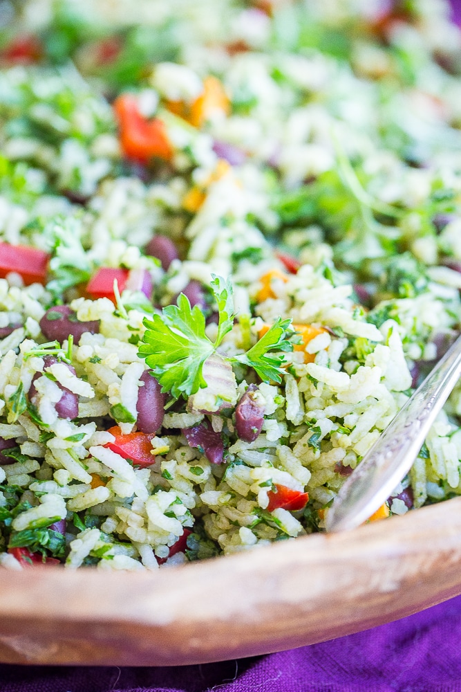 A close up view of Green Rice with Black Beans and Sweet Potato in a wooden bowl