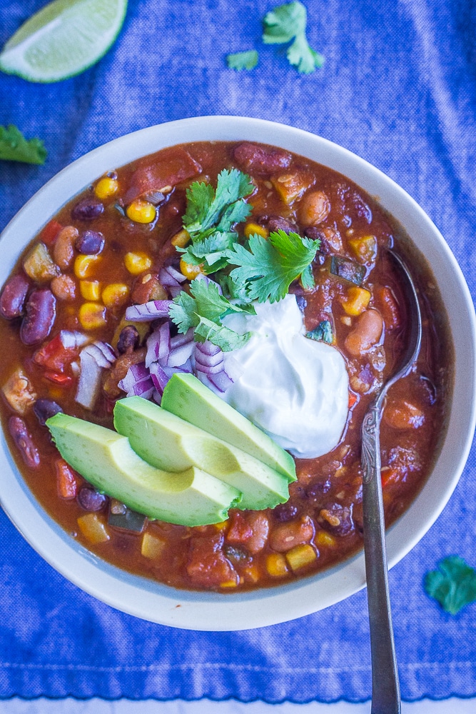 A bowl of instant pot vegetarian chili on a blue napkin