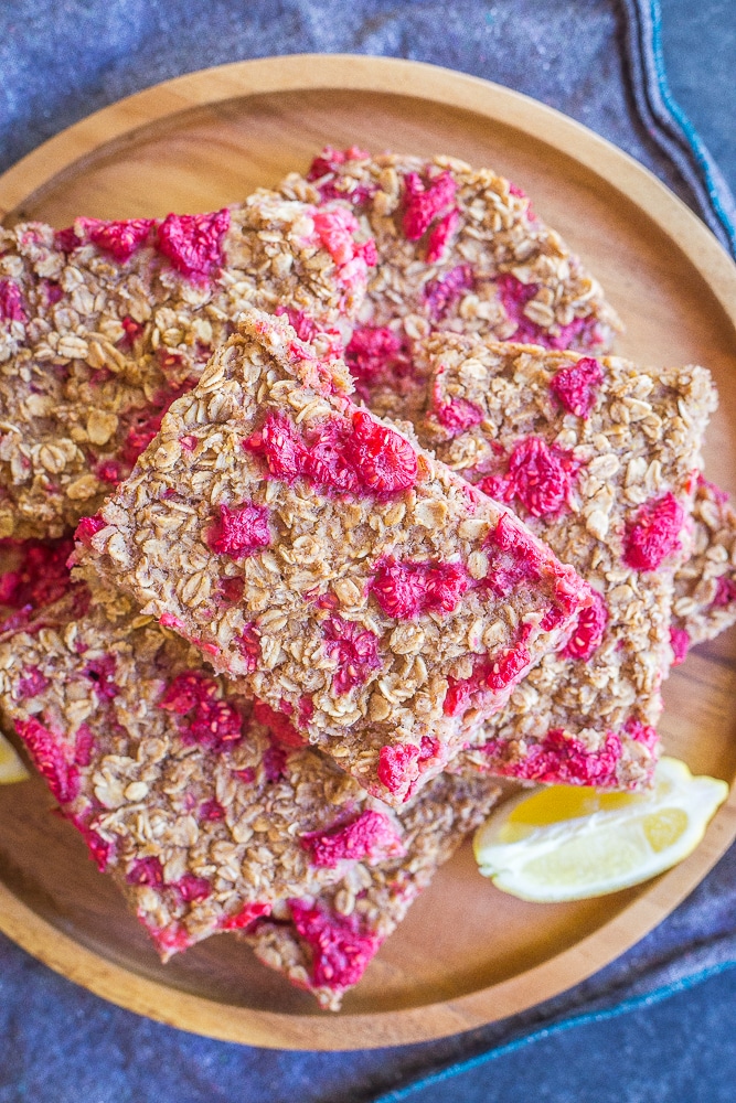 A top down view of Lemon Raspberry Baked Oatmeal on a wooden plate