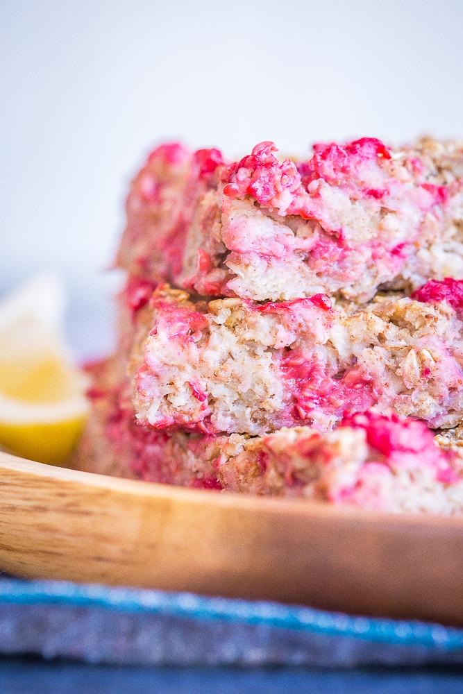 Lemon Raspberry Baked Oatmeal Stacked up in a wooden dish