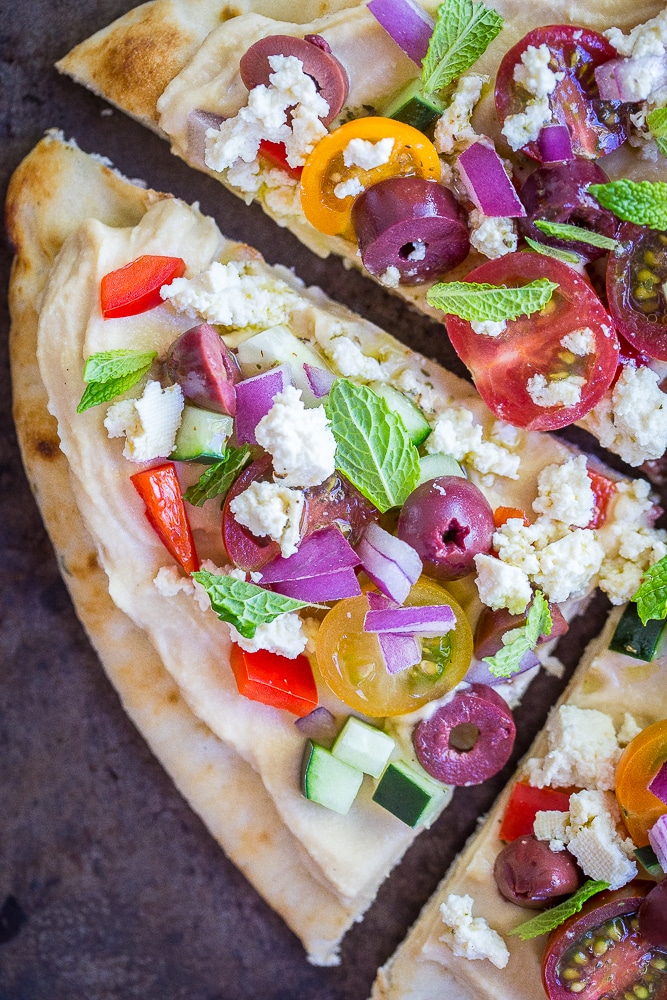 A close up of a slice of No Cook Mediterranean Hummus Pizzas