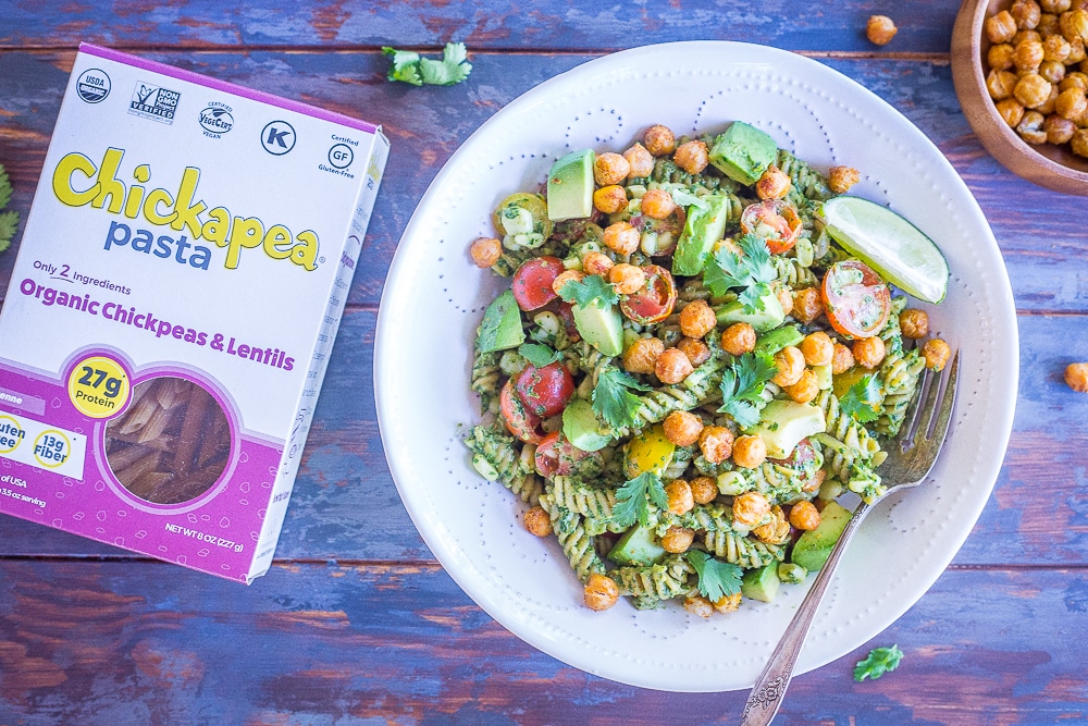 A bowl of Southwestern Pesto Pasta with Crispy Chickpeas next to a box of Chickapea Pasta