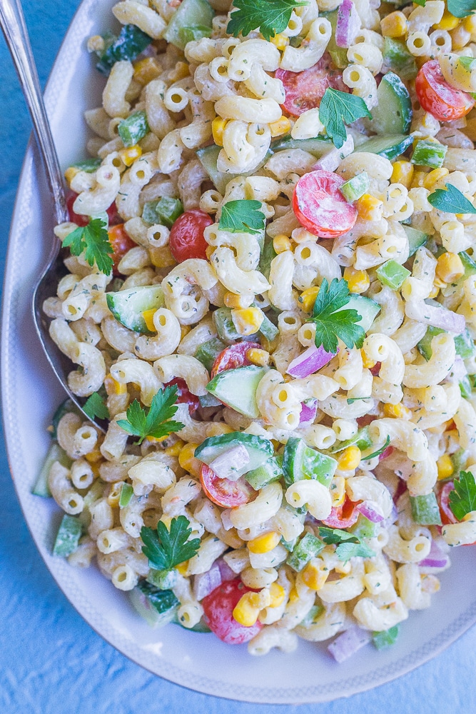 Close up view of Healthier Mayo Free Macaroni Salad on a serving platter with two spoons